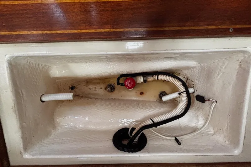 Slide: The Image of 1993 Hunter 33.5 boat bilge area with hoses and pump components. - 29