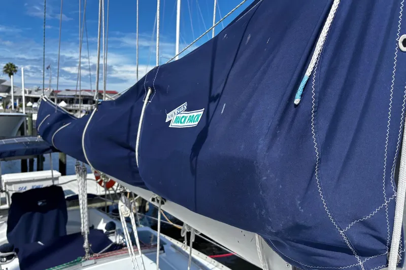 Slide: The Image of 1993 Hunter 33.5 sailboat with blue sail cover at marina. - 4