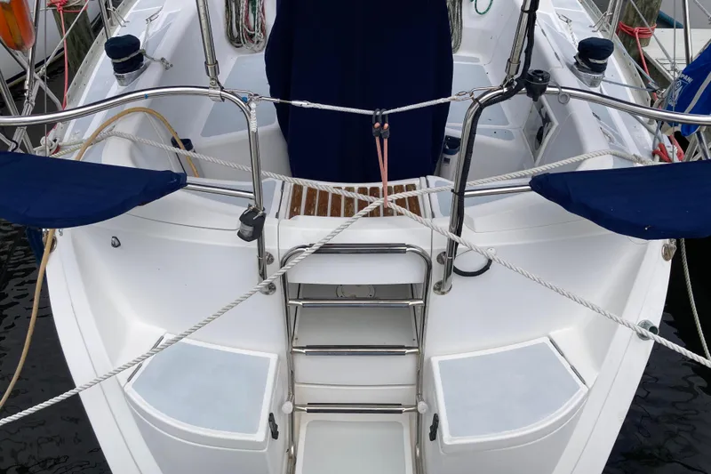 Slide: The Image of Cockpit of a 1993 Hunter 33.5 sailboat with stainless steel ladder and blue covers. - 9