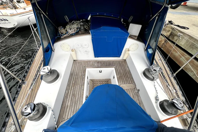 Slide: The Image of Cockpit of 1983 CT 38 Warwick sailboat with blue canopy and wooden deck. - 5