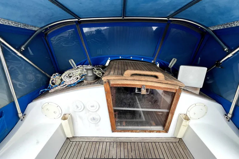 Slide: The Image of 1983 CT 38 Warwick boat cockpit with blue canopy and wooden hatch. - 7