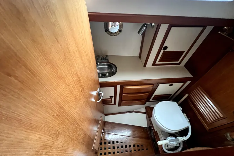 Slide: The Image of 1983 CT 38 Warwick yacht bathroom with wooden cabinetry and compact design. - 9