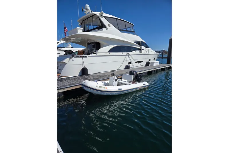 Slide: The Image of Luxury yacht docked with a 2016 Mercury Console boat in a marina. - 3