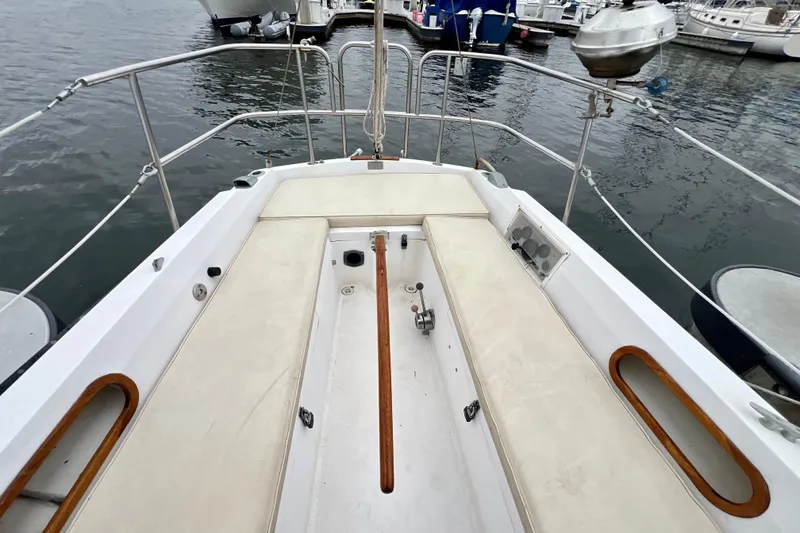 Slide: The Image of Cockpit of a 1985 Catalina 27 sailboat, featuring cushioned seating and wooden accents. - 11