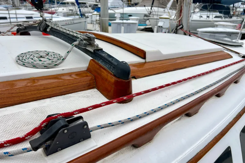 Slide: The Image of Close-up of 1985 Catalina 27 sailboat deck with ropes and wooden trim. - 12