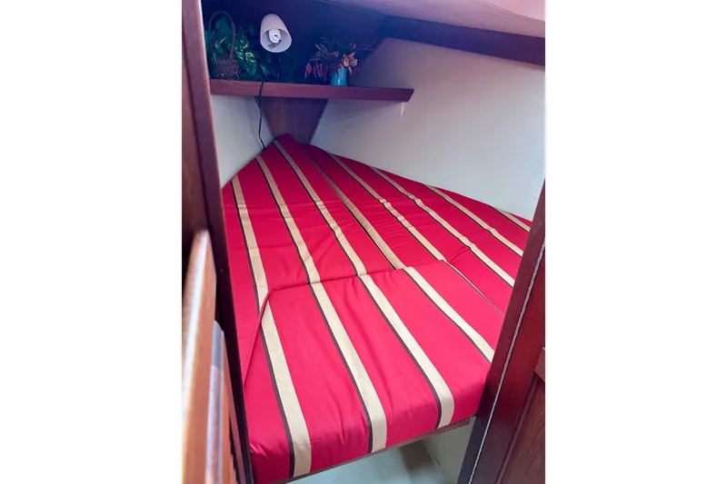 Slide: The Image of Cozy cabin interior of 1985 Catalina 27 sailboat with striped red bedding. - 23