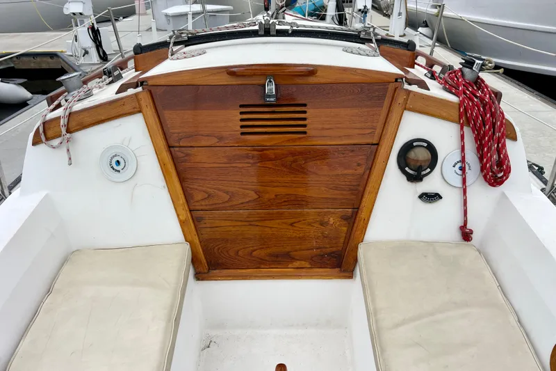 Slide: The Image of Cockpit of a 1985 Catalina 27 sailboat with wooden hatch and seating. - 9