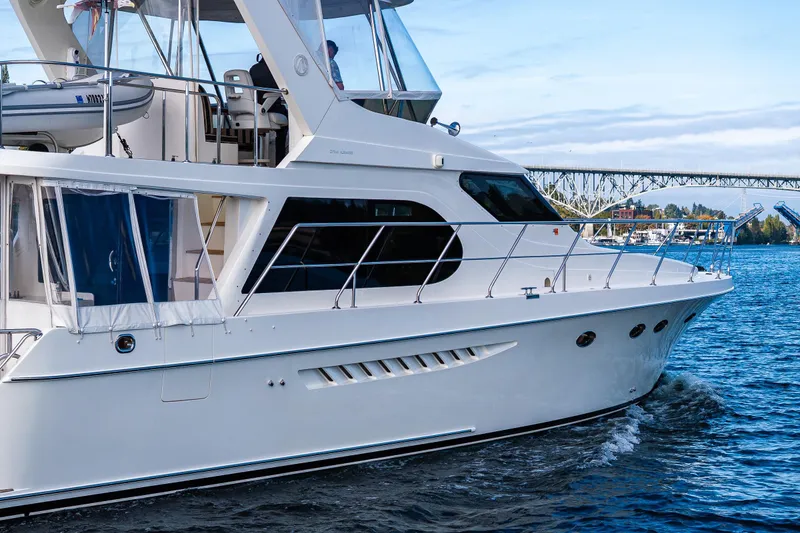 Slide: The Image of 2009 Ocean Alexander 52 Sedan yacht cruising on a scenic waterway. - 15