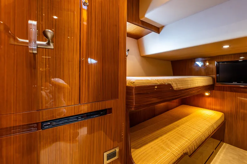 Slide: The Image of Luxurious 2009 Ocean Alexander 52 Sedan yacht interior with wooden finish and cozy bunk beds. - 42