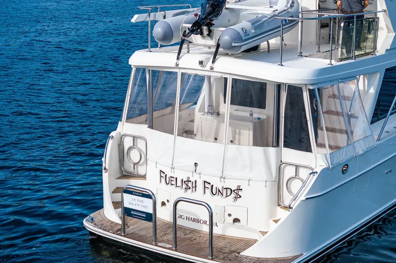 Slide: The Image of Ocean Alexander 52 Sedan 2009 yacht on water, rear view with dinghy on extended hardtop. - 7