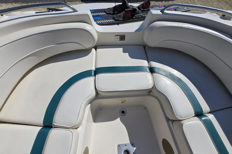 Slide: The Image of 1999 Bayliner 2459 Rendezvous DX/LX boat interior with cushioned seating. - 11