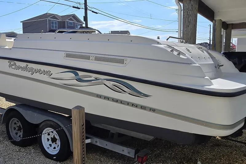 Slide: The Image of 1999 Bayliner 2459 Rendezvous DX/LX boat on trailer, side view. - 15
