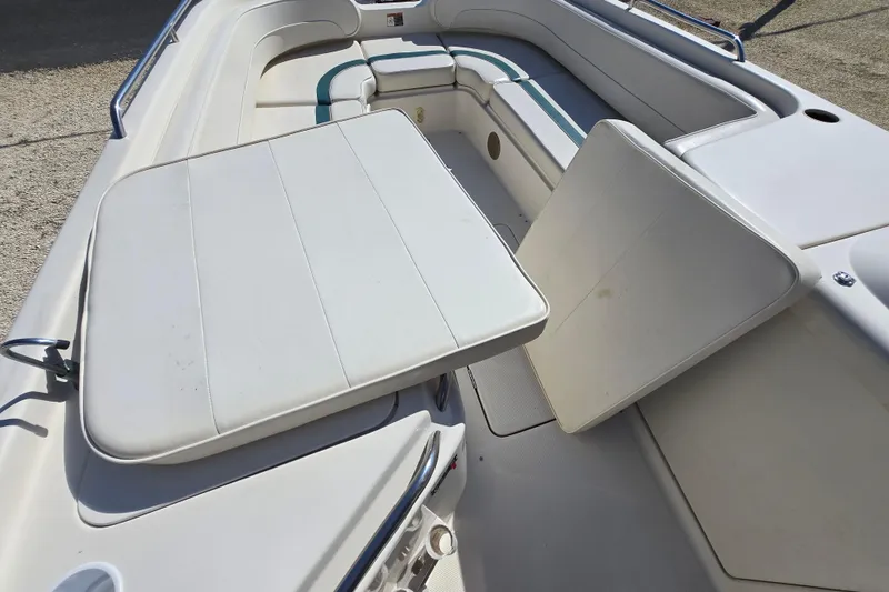 Slide: The Image of 1999 Bayliner 2459 Rendezvous DX/LX boat interior with seating and table. - 20
