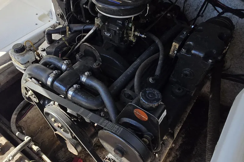 Slide: The Image of 1999 Bayliner 2459 Rendezvous DX/LX engine compartment with visible components and belts. - 21