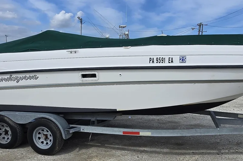 Slide: The Image of 1999 Bayliner 2459 Rendezvous DX/LX boat on trailer, covered, with registration number PA 9591 EA. - 26