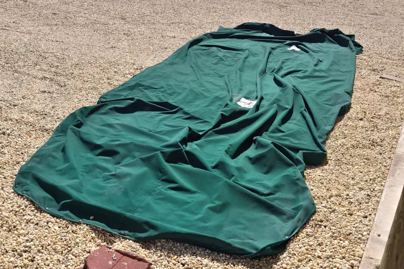 Slide: The Image of Green boat cover for 1999 Bayliner 2459 Rendezvous DX/LX on gravel surface. - 30