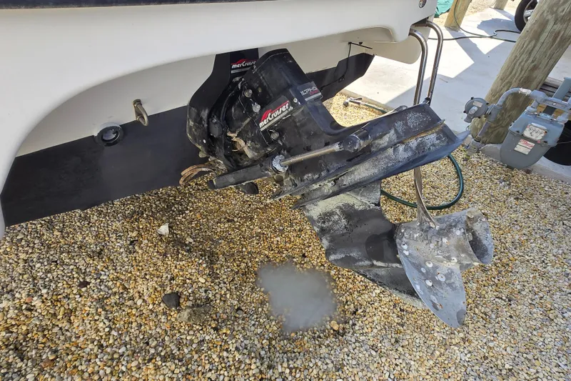 Slide: The Image of 1999 Bayliner 2459 Rendezvous DX/LX boat outboard motor on gravel surface. - 31