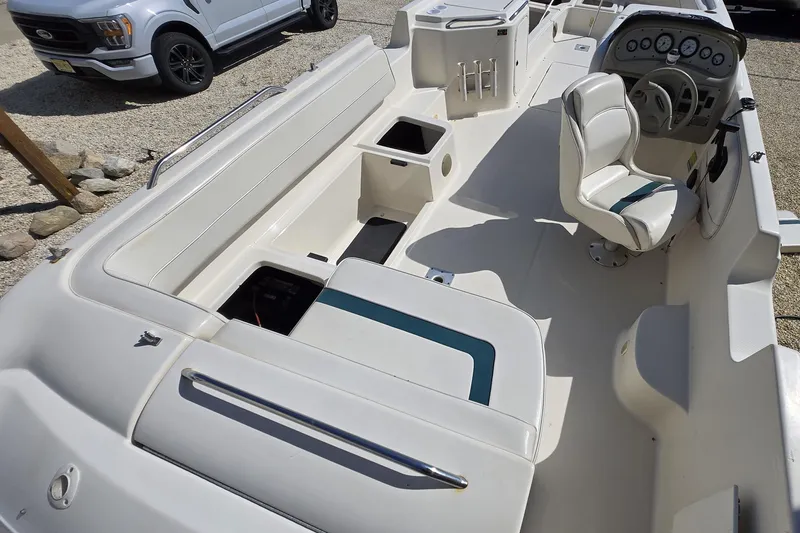 Slide: The Image of 1999 Bayliner 2459 Rendezvous DX/LX boat interior with seating and steering console. - 32