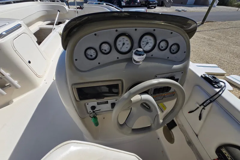 Slide: The Image of 1999 Bayliner 2459 Rendezvous DX/LX boat dashboard with steering wheel and gauges. - 4