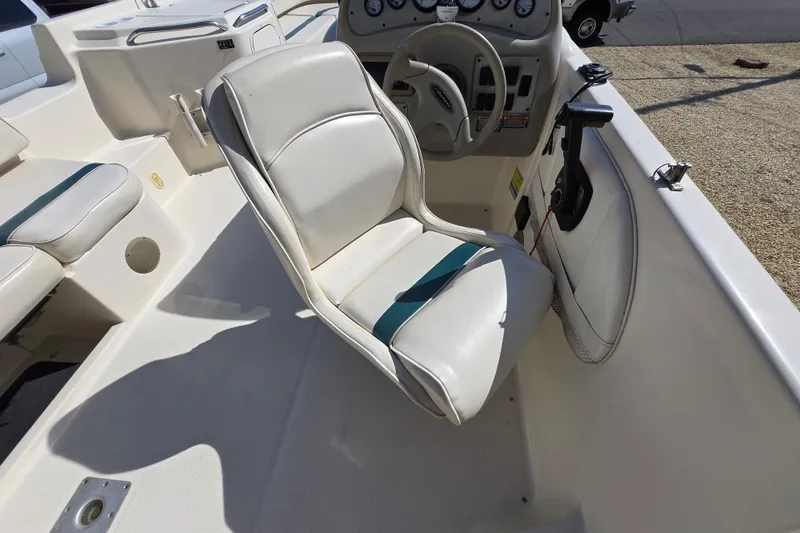 Slide: The Image of 1999 Bayliner 2459 Rendezvous DX/LX boat interior with steering wheel and seating. - 7