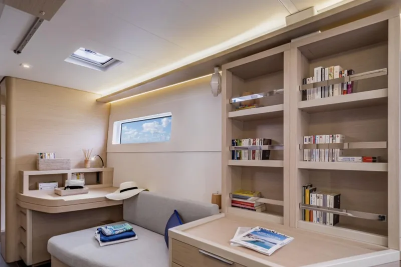 Slide: The Image of Luxurious interior of 2026 Lagoon 46 yacht with bookshelves and seating area. - 5