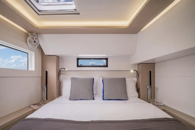 Slide: The Image of Luxurious bedroom interior of 2026 Lagoon 46 yacht with modern design and cozy bedding. - 7