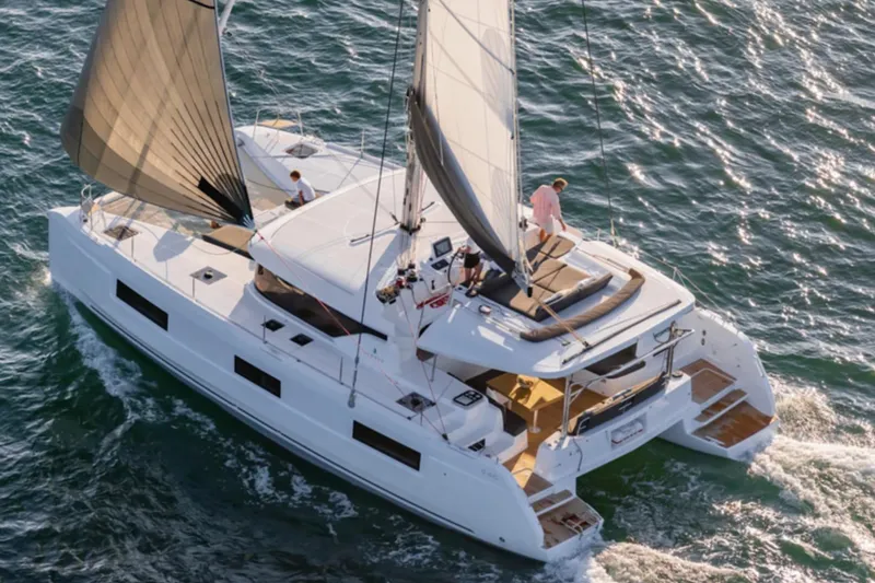 Slide: The Image of 2026 Lagoon 46 ICONIC catamaran sailing on open water, aerial view. - 13