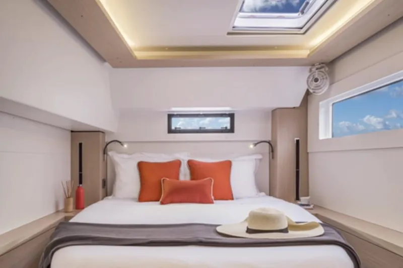 Slide: The Image of Luxurious bedroom interior of 2026 Lagoon 46 ICONIC yacht with skylight and modern decor. - 6
