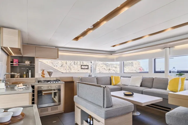 Slide: The Image of Luxurious interior of 2026 Lagoon 51 yacht with modern kitchen and spacious seating area. - 10