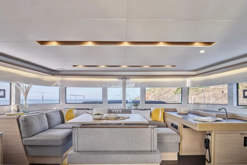 Slide: The Image of Luxurious interior of 2026 Lagoon 51 yacht with modern seating and panoramic windows. - 11