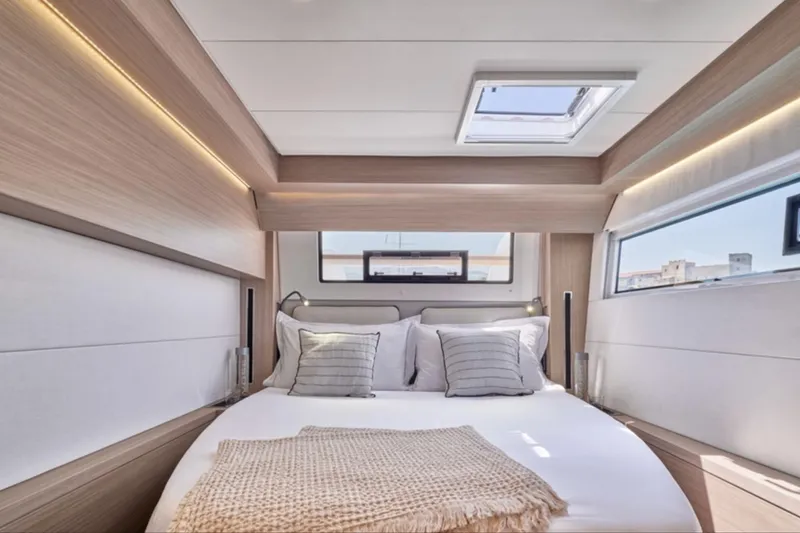 Slide: The Image of Luxurious bedroom interior of 2026 Lagoon 51 yacht with modern design and natural light. - 7