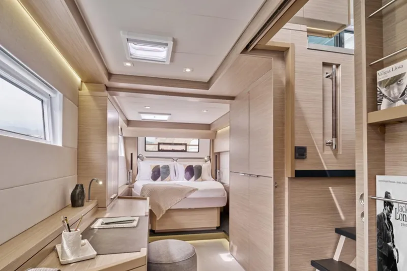 Slide: The Image of Luxurious interior of 2026 Lagoon 51 yacht with modern bedroom and workspace. - 8