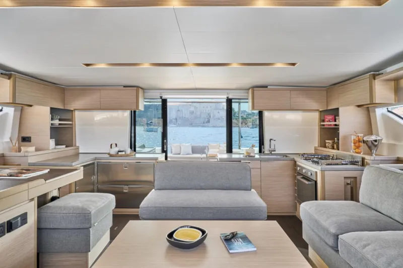 Slide: The Image of Luxurious interior of 2026 Lagoon 51 ICONIC yacht with modern kitchen and seating area. - 12
