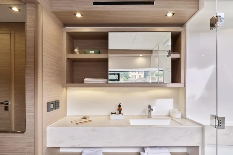 Slide: The Image of Modern bathroom interior of Lagoon 51 ICONIC yacht, featuring sleek design and wooden accents. - 5