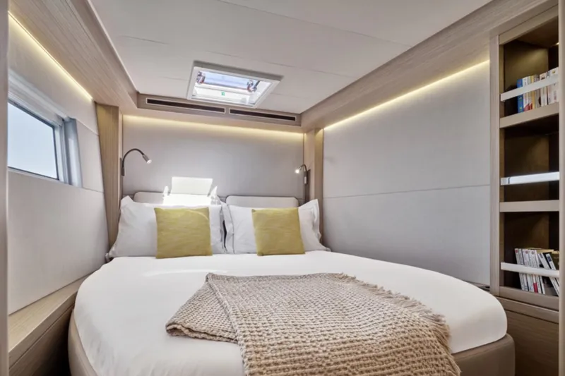 Slide: The Image of Luxurious bedroom interior of 2026 Lagoon 51 ICONIC yacht with modern design and cozy bedding. - 6