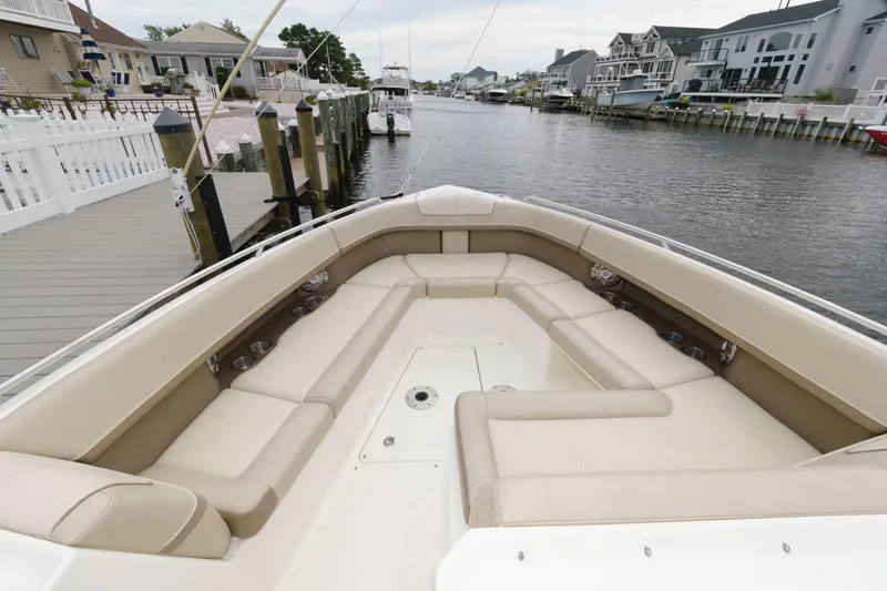 Slide: The Image of 2014 Formula 350 Crossover Bowrider with spacious seating docked by waterfront homes. - 10