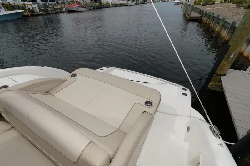 Slide: The Image of 2014 Formula 350 Crossover Bowrider at dock, featuring spacious seating and sleek design. - 11