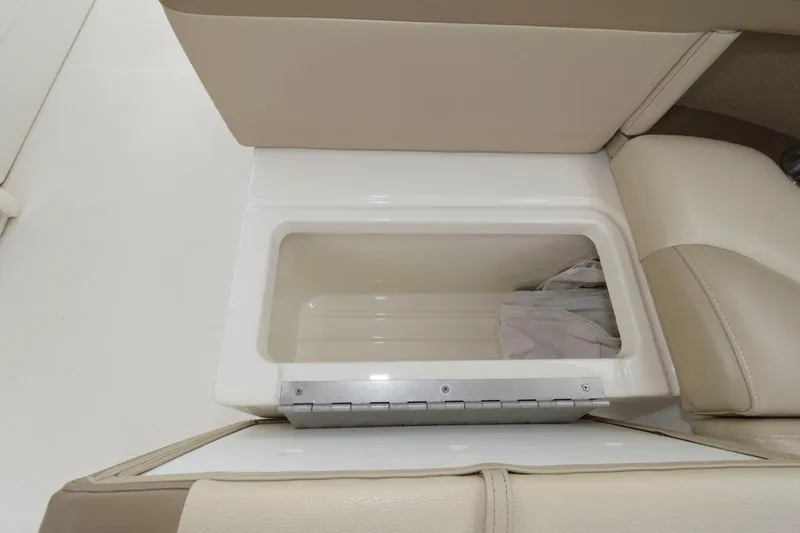 Slide: The Image of 2014 Formula 350 Crossover Bowrider storage compartment with beige seating. - 13