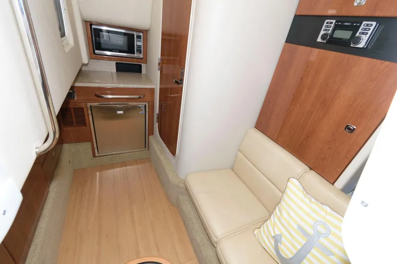 Slide: The Image of Interior of 2014 Formula 350 Crossover Bowrider with kitchenette and seating area. - 14