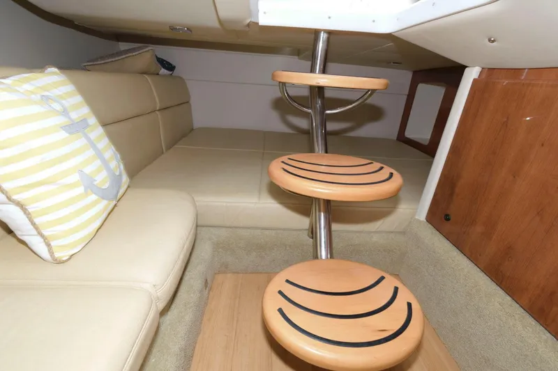 Slide: The Image of 2014 Formula 350 Crossover Bowrider cabin interior with beige seating and wooden steps. - 15