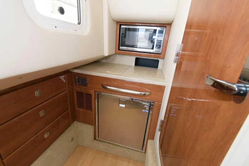 Slide: The Image of 2014 Formula 350 Crossover Bowrider cabin with microwave and mini-fridge. - 17