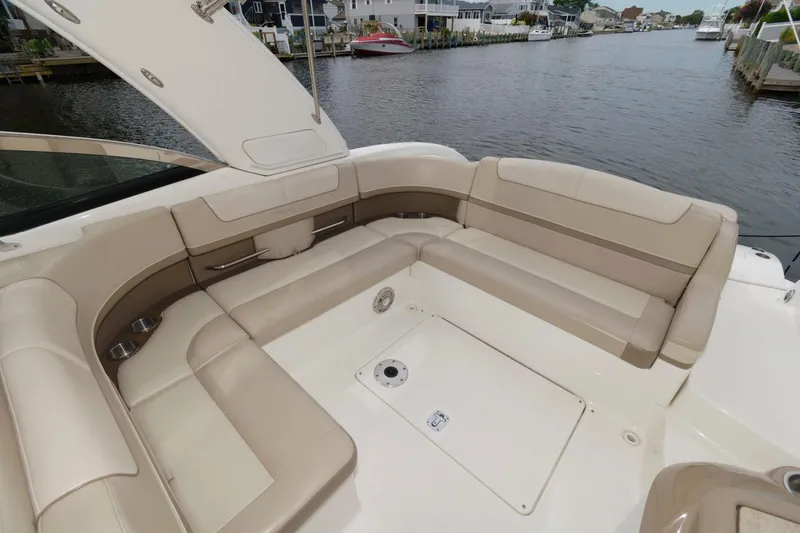 Slide: The Image of 2014 Formula 350 Crossover Bowrider with spacious seating on a calm waterfront. - 4