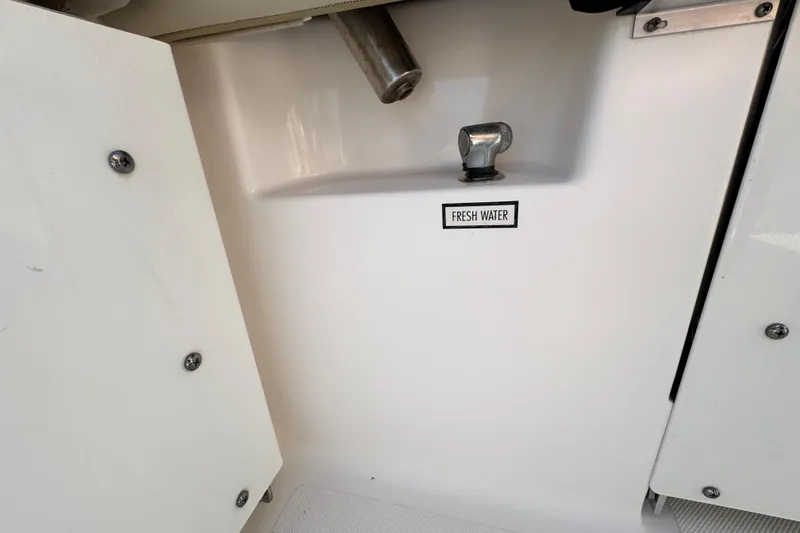 Slide: The Image of Fresh water access on 2015 Pursuit DC 265 Dual Console boat. - 10