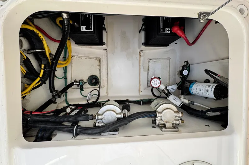 Slide: The Image of 2015 Pursuit DC 265 Dual Console engine compartment with wiring and components. - 14