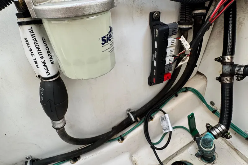 Slide: The Image of Engine compartment of 2015 Pursuit DC 265 Dual Console with fuel system components. - 17