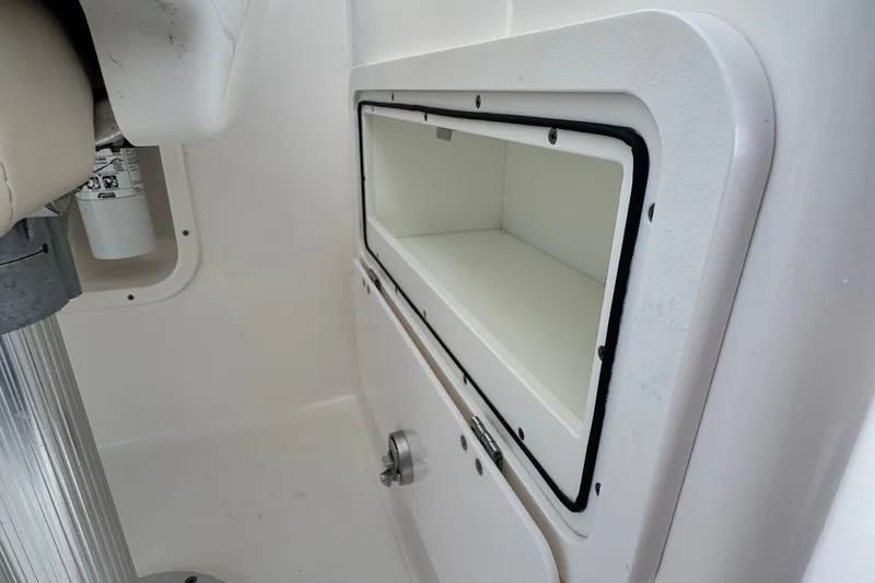 Slide: The Image of 2015 Pursuit DC 265 Dual Console storage compartment interior view. - 27