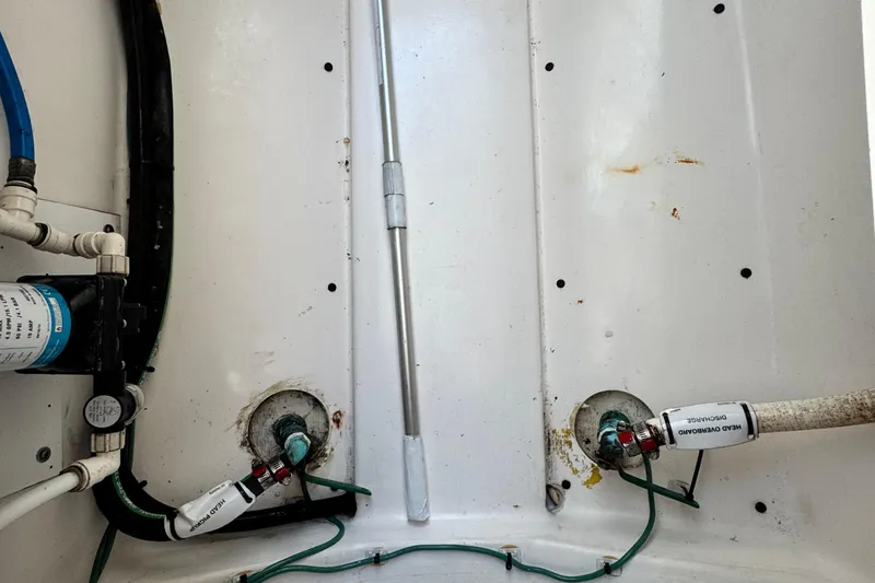 Slide: The Image of 2015 Pursuit DC 265 Dual Console boat plumbing system with hoses and fittings. - 33