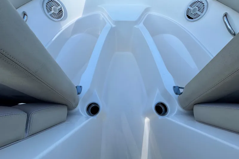 Slide: The Image of Interior view of 2015 Pursuit DC 265 Dual Console boat, featuring seating and speakers. - 37