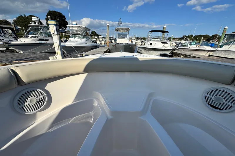 Slide: The Image of 2015 Pursuit DC 265 Dual Console boat docked at marina under blue sky. - 39