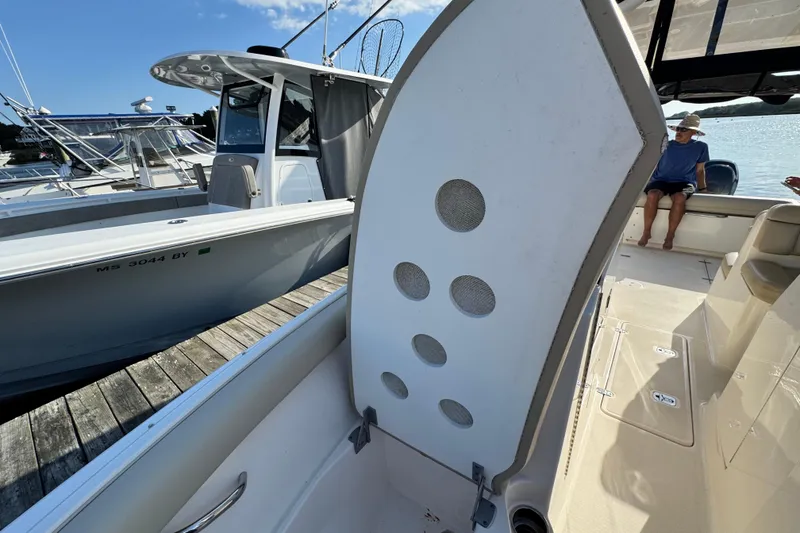 Slide: The Image of 2015 Pursuit DC 265 Dual Console boat interior with open storage compartment. - 40